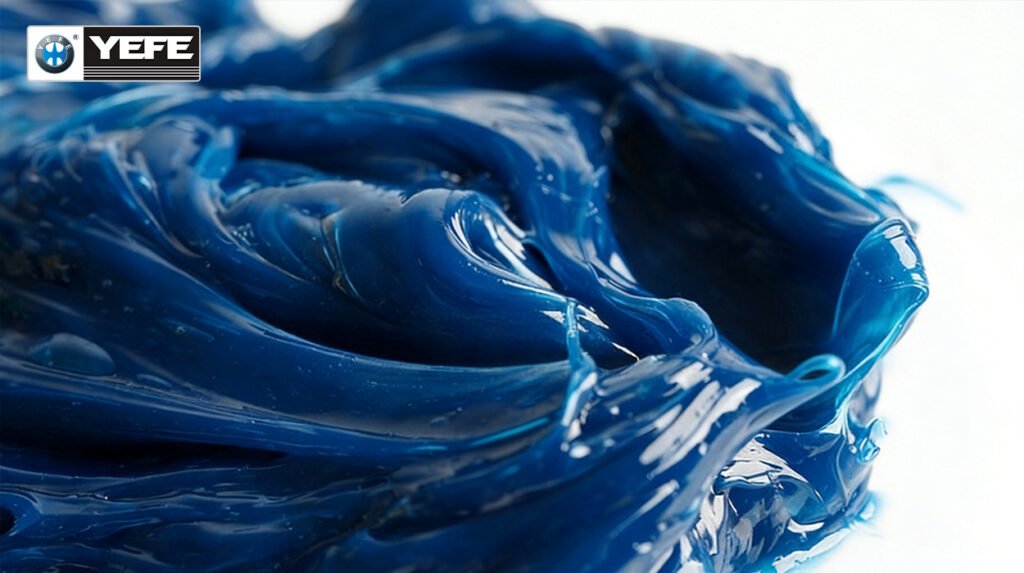 Glossy blue YEFE grease with smooth peaks and high adhesion, formulated for shock loads, dust protection and water resistance in construction equipment like excavators and loaders where standard grease would fail under heavy vibration and contamination.