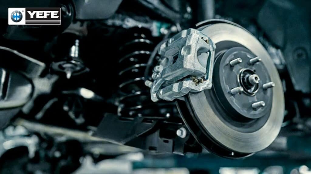 Close-up of a vehicle disc brake rotor and caliper assembly, illustrating the hydraulic components where synthetic and conventional brake fluids operate and how fluid choice affects braking consistency, fade resistance and service life.