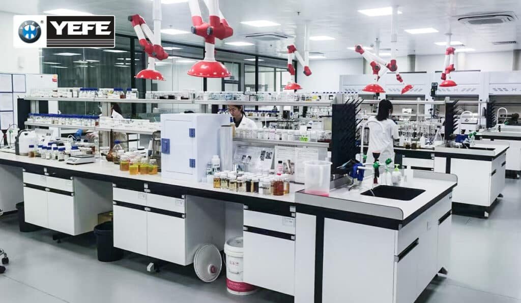 YEFE chemists working in a modern lubricant testing laboratory with bottles of engine oil samples and analysis equipment, demonstrating ISO‑style quality control, COA reporting and batch traceability that prevent common outsourcing mistakes in OEM lubricant manufacturing