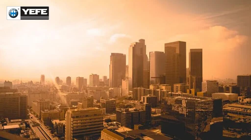 Golden sunset over modern city skyline representing extreme heat stress in tropical regions where YEFE engine oil formulations deliver superior viscosity stability oxidation resistance and film strength for reliable performance in hot climate countries