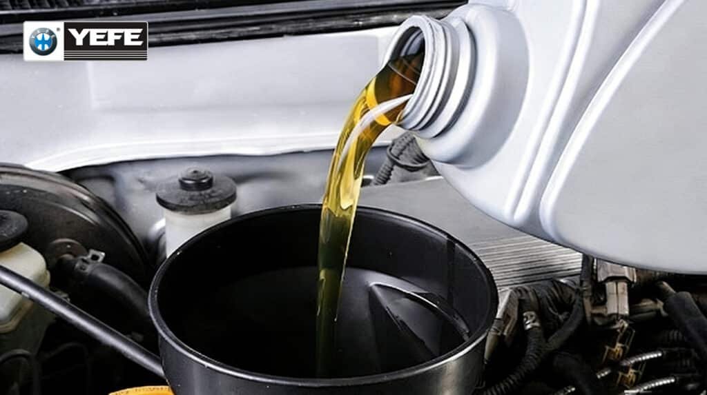 Golden YEFE hydraulic oil pouring from container into machinery oil reservoir, ensuring proper ISO VG grade viscosity for pumps, valves, and long service intervals in industrial systems
