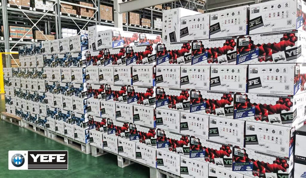 Stacks of YEFE engine oil cartons on pallets in a warehouse, showing large‑volume OEM lubricant production, secure packaging and logistics support for distributors building their own lubricant brands and export business