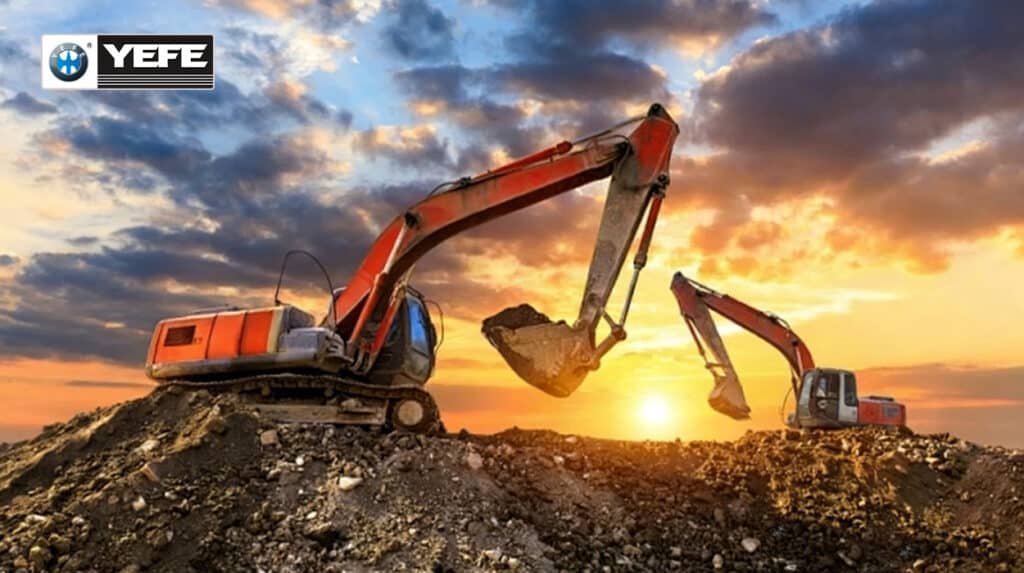 Two excavators digging on a dirt mound at sunset, representing construction machinery operating in hot, high-load conditions that require high-temperature hydraulic oil with strong thermal stability, oxidation resistance, and correct viscosity to prevent pump and seal wear.