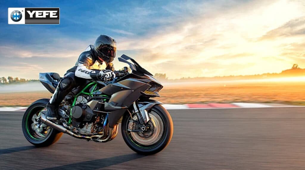 Rider on a high-performance 4-stroke sport motorcycle leaning into a track turn at sunset, showcasing the need for YEFE 4-stroke motorcycle oil with JASO MA/MA2 standards for shear stability, gear protection, and wet clutch performance.