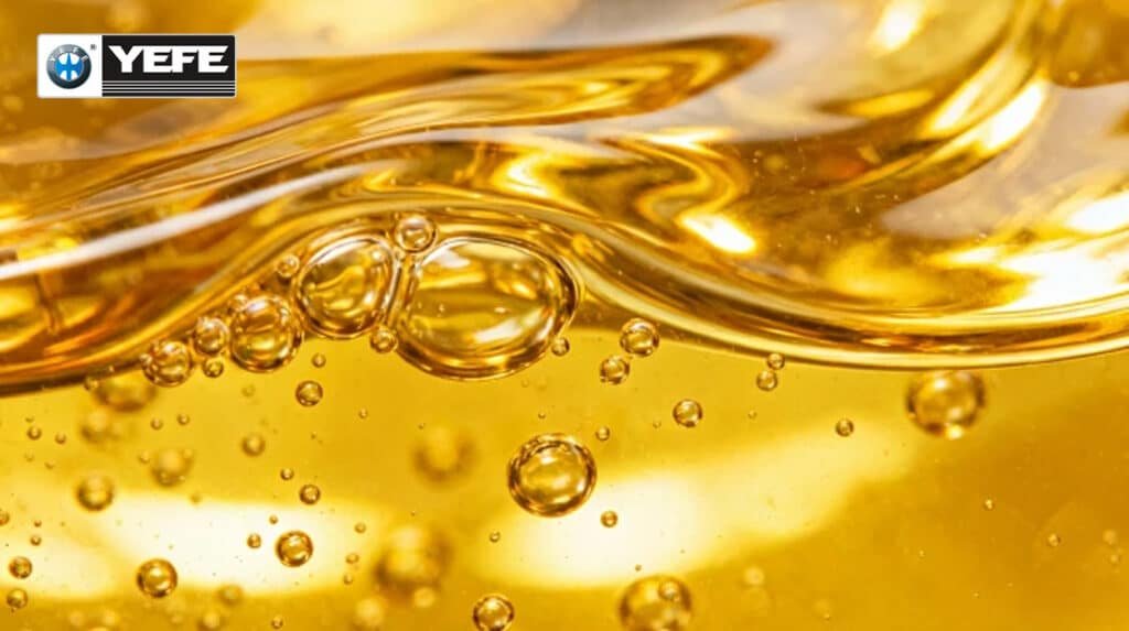 Close-up of clear golden YEFE hydraulic oil waves with bubbles, exemplifying ISO-compliant HM category properties like oxidation stability and anti-wear for industrial hydraulic applications