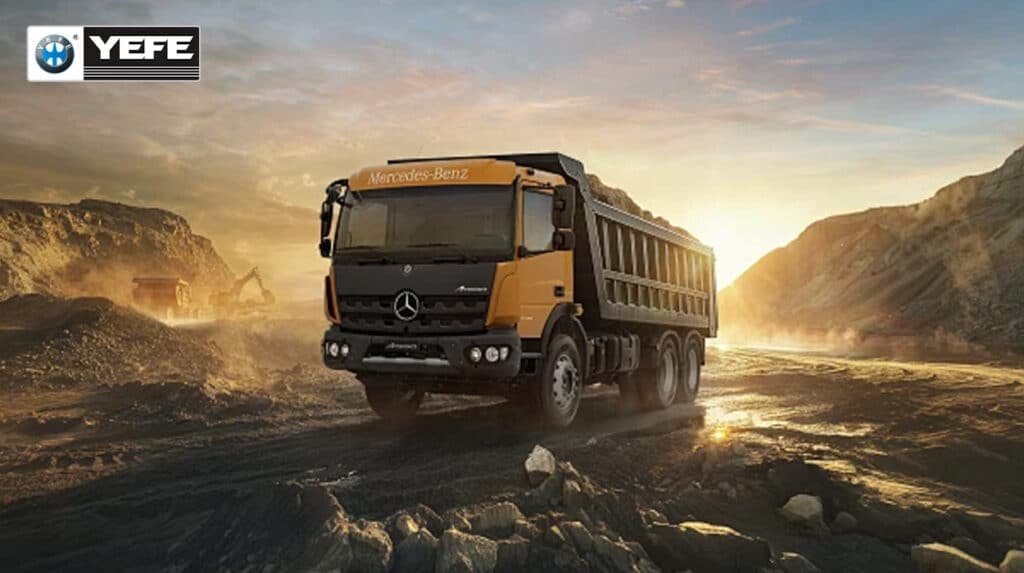Mercedes-Benz dump truck operating on construction site demonstrating the importance of proper hydraulic oil selection for mobile equipment, showing heavy-duty hydraulic systems requiring anti-wear protection and temperature stability in outdoor environments