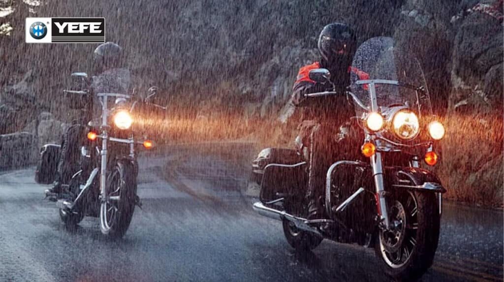 Two motorcyclists riding touring bikes in heavy rain on a mountain road, symbolizing moisture contamination risks to motorcycle oil during humid export shipping, temperature swings and poor warehouse storage that can lead to additive breakdown, reduced shelf life and engine performance issues.