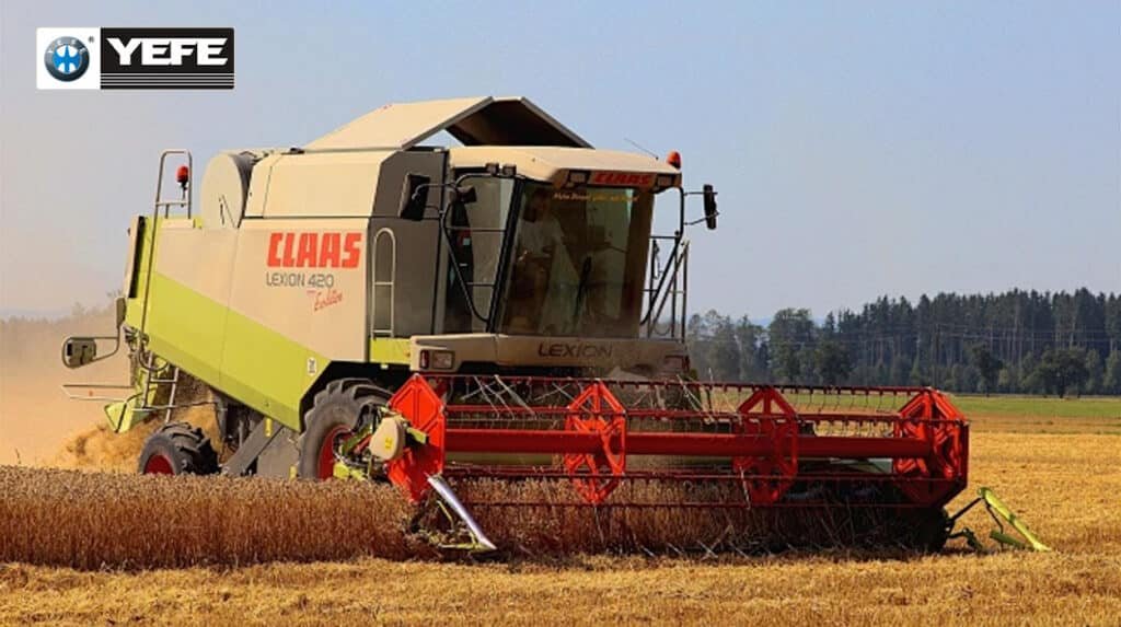 YEFE transmission oil for agricultural machinery showing CLAAS LEXION 420 combine harvester operating in field conditions with dust and heavy loads, demonstrating the need for specialized agricultural transmission fluid with shear stability, thermal protection, anti-wear additives, and contamination resistance to protect farm equipment transmissions during continuous harvesting operations, variable speed demands, and harsh environmental conditions