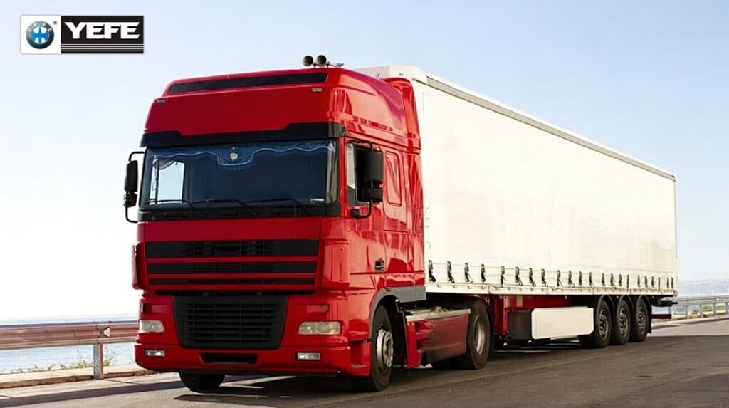 A red heavy-duty semi-truck with a white trailer cruises along a coastal highway under clear skies, symbolizing the long-haul, high-load conditions that define commercial freight transport. This image represents the real-world operating environment where engines face sustained thermal stress, prolonged operation, and heavy mechanical loads—conditions that demand a high-performance lubricant like YEFE Sports CF-4/E3 20W-50. Formulated for diesel engines in trucks and buses, this oil delivers superior oxidation resistance, soot dispersion, and wear protection to ensure engine reliability, extended drain intervals, and reduced maintenance costs across thousands of miles.