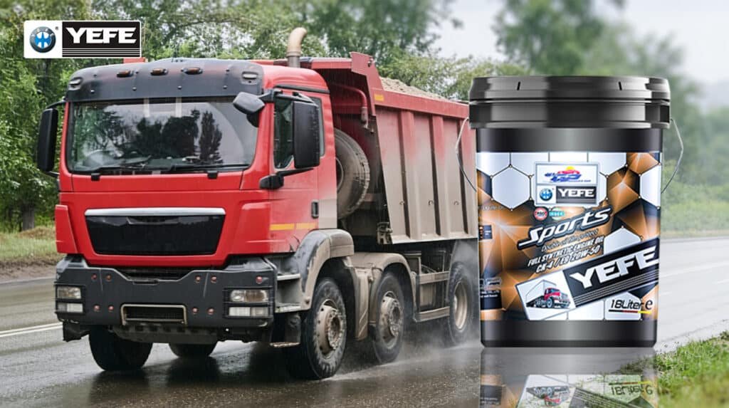 Red heavy-duty dump truck operating on a wet road alongside a 18-liter pail of YEFE Sports full synthetic diesel engine oil, illustrating how optimized viscosity and shear stability maintain a protective lubricating film under high mechanical stress and varying temperatures, reducing friction and wear to ensure engine longevity and fuel efficiency in demanding operational environments.