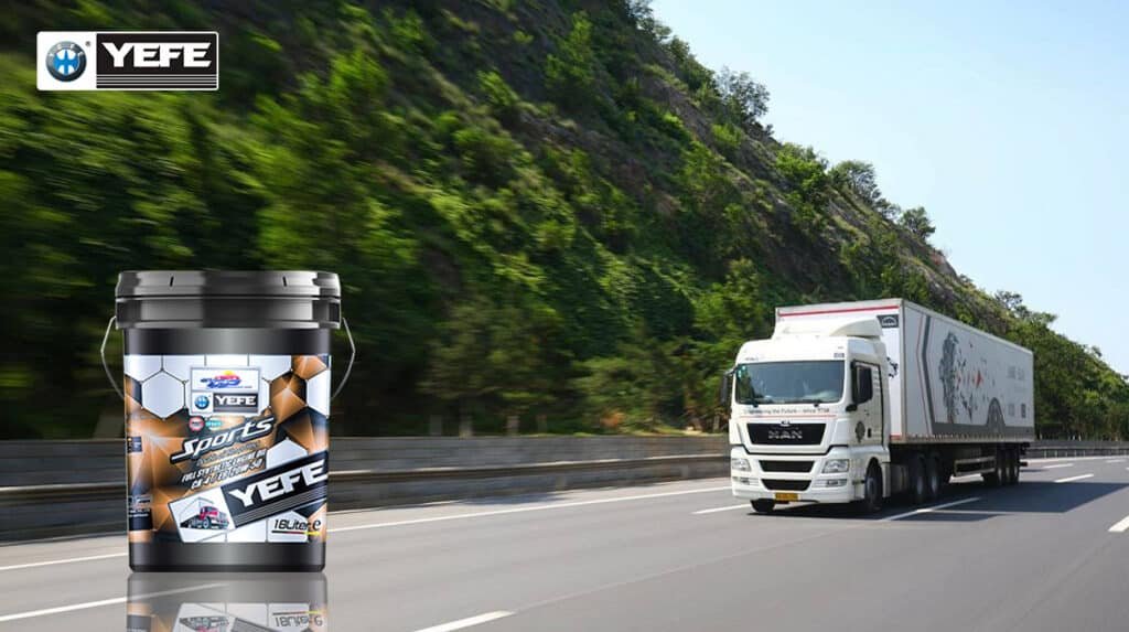 A white MAN TGX heavy-duty long-haul semi-truck driving on a multi-lane highway with lush green hills in the background, alongside a 18-liter pail of YEFE Sports full synthetic diesel engine oil (CH-4/E3 20W-50) displayed in the foreground; the image highlights the product’s double oil film protection technology designed to maintain viscosity stability, resist thermal breakdown, and provide superior wear protection under sustained high-heat and continuous load conditions typical of long-haul transportation on high-speed routes.