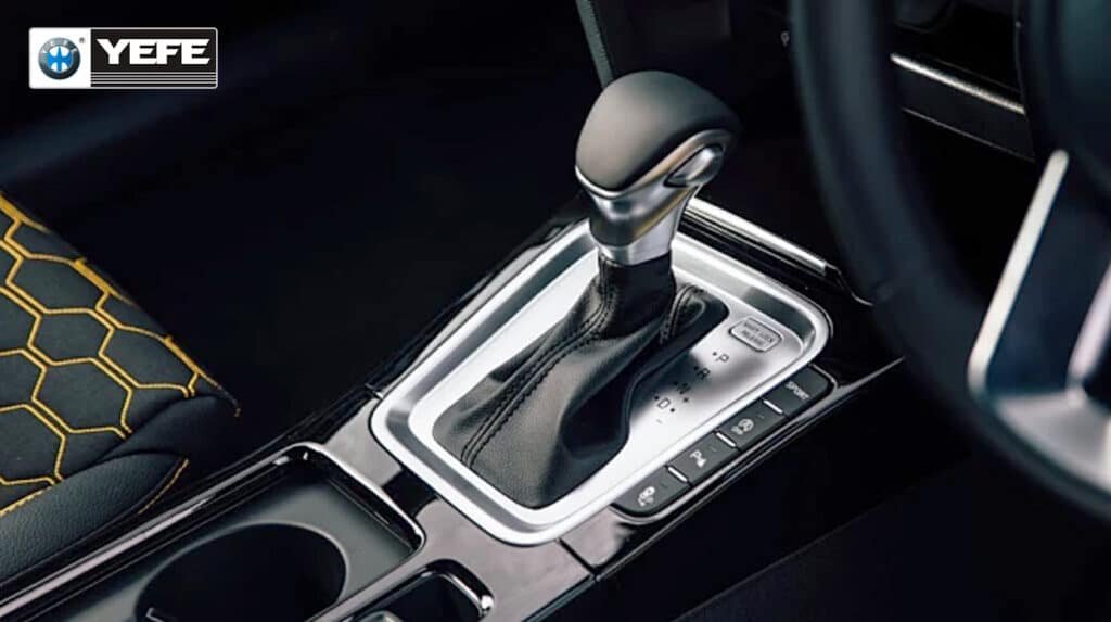 Close‑up of a modern automatic transmission gear lever in a passenger car interior, illustrating where automatic transmission fluid (ATF) is used and highlighting YEFE as a professional transmission oil supplier.