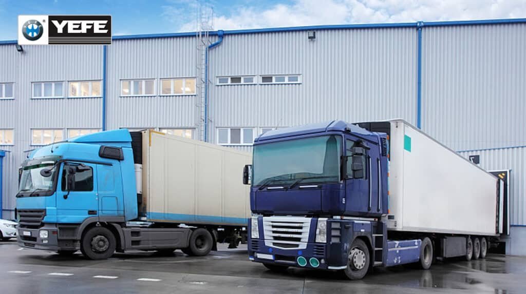 YEFE heavy-duty transmission oil for commercial trucks and buses showing fleet vehicles at distribution facility, demonstrating the need for specialized transmission fluid with Eaton PS-386 and Allison TES-668 approvals, shear stability, thermal oxidation resistance, and extended drain intervals for reliable fleet operations and reduced maintenance costs in high-load commercial vehicle applications