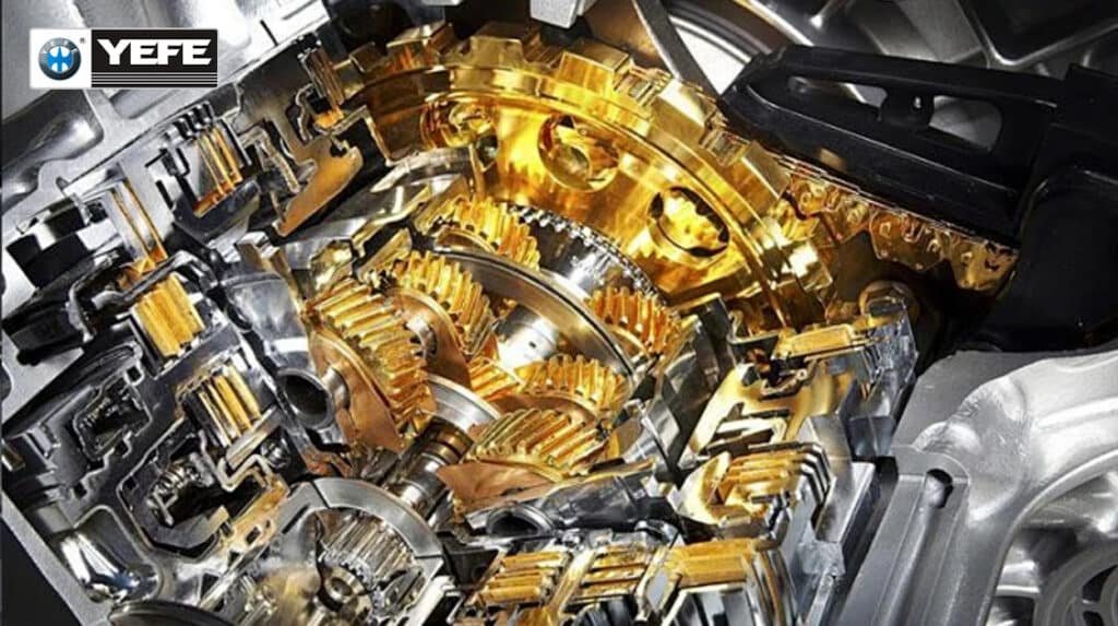 Detailed cutaway of a manual transmission showing multiple intermeshing gears coated with golden manual transmission oil, illustrating how YEFE MTF provides extreme‑pressure protection and wear resistance for gearbox gears and synchronizers.