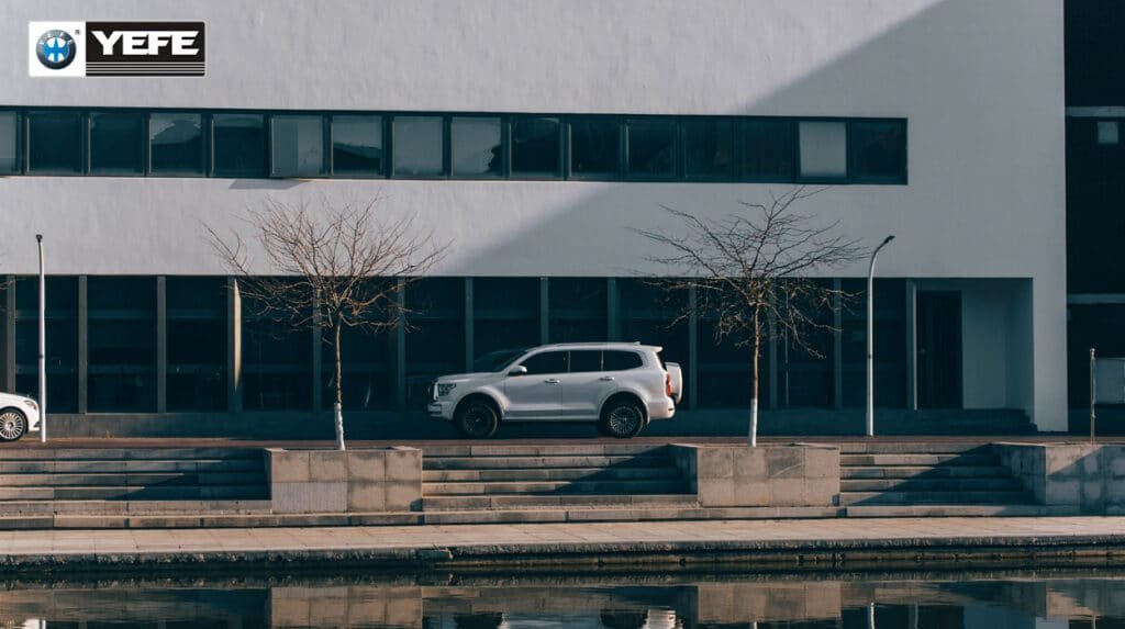 A white Tank 500 SUV is parked in front of a modern building, representing the sophisticated engineering of contemporary vehicles discussed in the article "Why Engine Oil Is Critical for Modern Passenger Cars." This image symbolizes the advanced materials and complex systems, such as turbocharged engines and start-stop technology, that place significant stress on engine oil. To ensure optimal performance and durability, these modern engines require lubricants with high oxidation stability, excellent shear resistance, and effective detergency to prevent wear and deposit buildup, highlighting the critical role of high-quality engine oil in maintaining the reliability and efficiency of today's passenger cars.