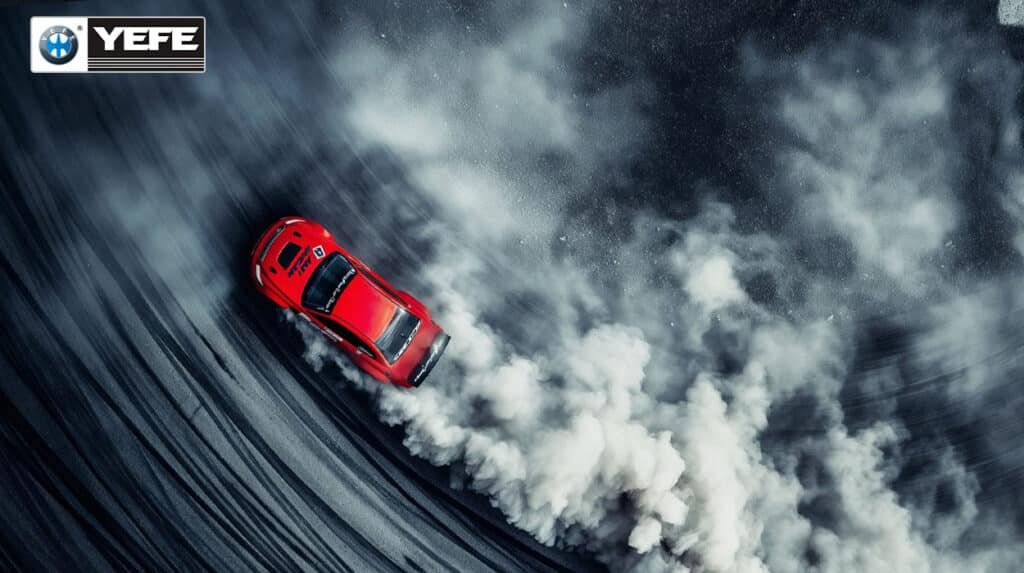 An aerial view of a red sports car drifting on a racetrack, creating massive tire smoke. This image visualizes the extreme mechanical and thermal stress placed on an engine during high-performance driving. It demonstrates the necessity of YEFE high-performance engine oil, which provides critical lubrication, wear protection, and thermal stability to prevent engine failure under such demanding conditions.