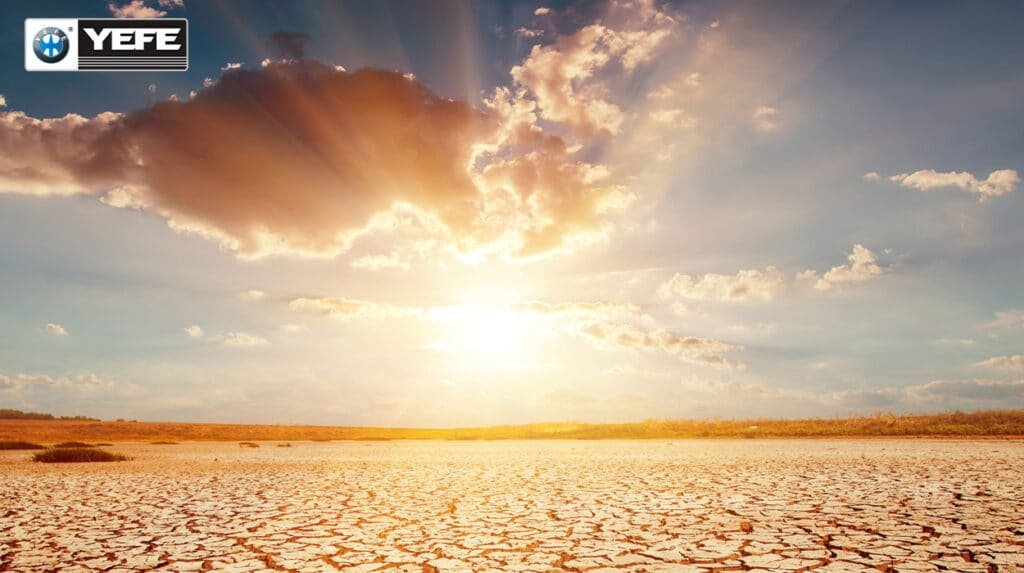 A cracked, dry desert plain under a blazing sun with dramatic cloud formations, depicting the extreme heat and thermal stress that engine oil faces in hot-climate regions. This image aligns with the article's discussion on how sustained high temperatures and poor heat dissipation in arid environments accelerate oil degradation, leading to viscosity instability, deposit formation, and shortened oil lifespan, highlighting the critical importance of thermal stability in lubricant formulation.