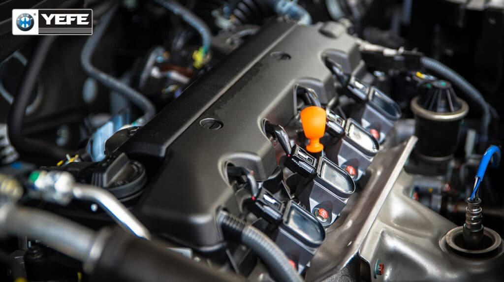 Close-up of gasoline engine valve cover, ignition coils and cooling pipeline components, YEFE OAT & HOAT coolant delivers stable boil-over resistance and anti-corrosion protection under sustained high ambient temperature for tropical, desert hot climate vehicle fleets, avoids radiator clogging and engine overheating in stop-and-go heavy traffic