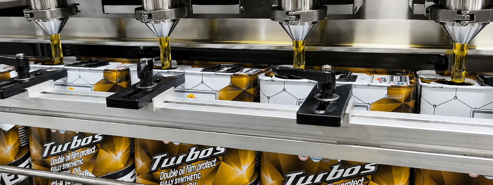 Automated filling line dispensing YEFE Turbos fully synthetic heavy-duty engine oil into metal containers