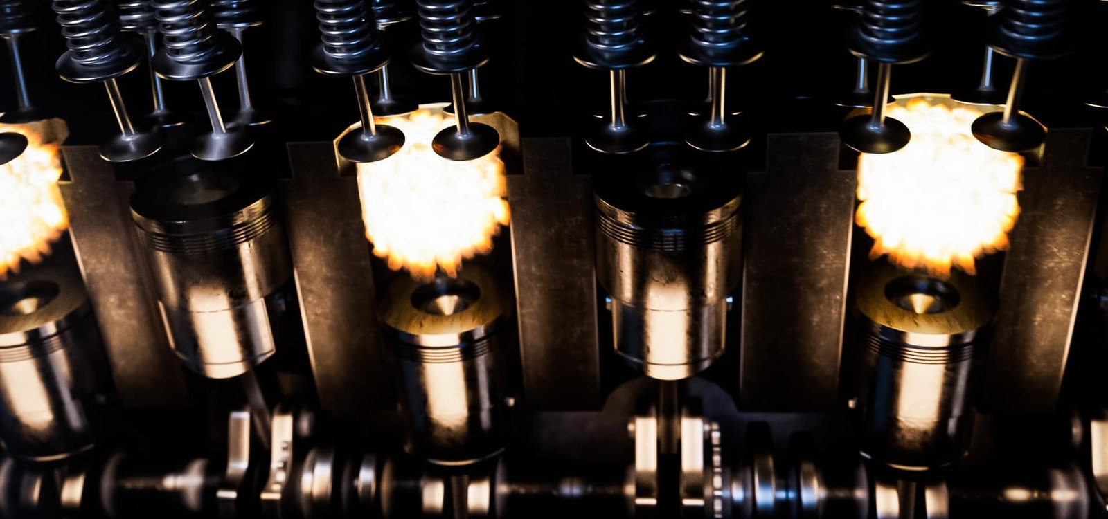 Internal combustion engine pistons and valves in operation, representing passenger car engine oil protection under high-temperature conditions